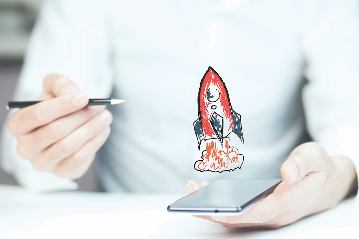 Businessman hand phone with red rocket