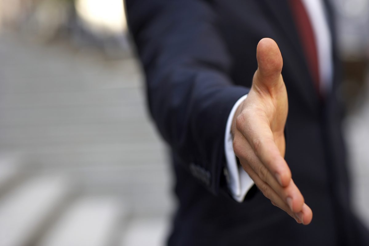 Businessman about to shake hands We can handle the truth.