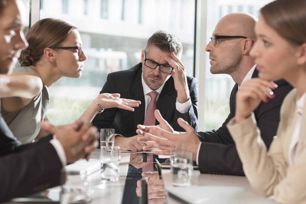 Poland, Warzawa, group of five businessmen in disagreement What to do when work ethics collide?