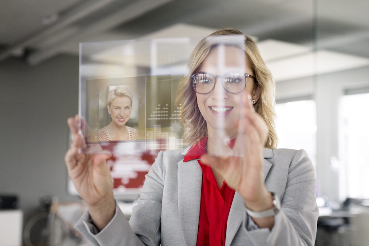 Businesswoman communicating via futuristic portable device Why embracing the intelligence revolution is a courageous decision