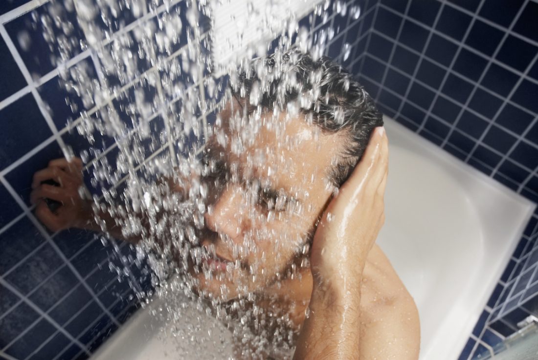 Close-up of a young man in the shower