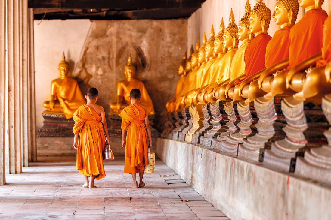 Two novices walking return and talking in old temple at Ayutthaya Province, Thailand