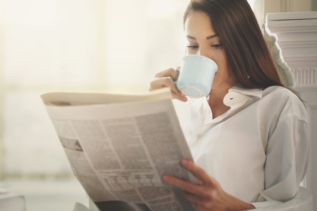 Morning coffee and newspapers. Slow morning: Start the day slow for success