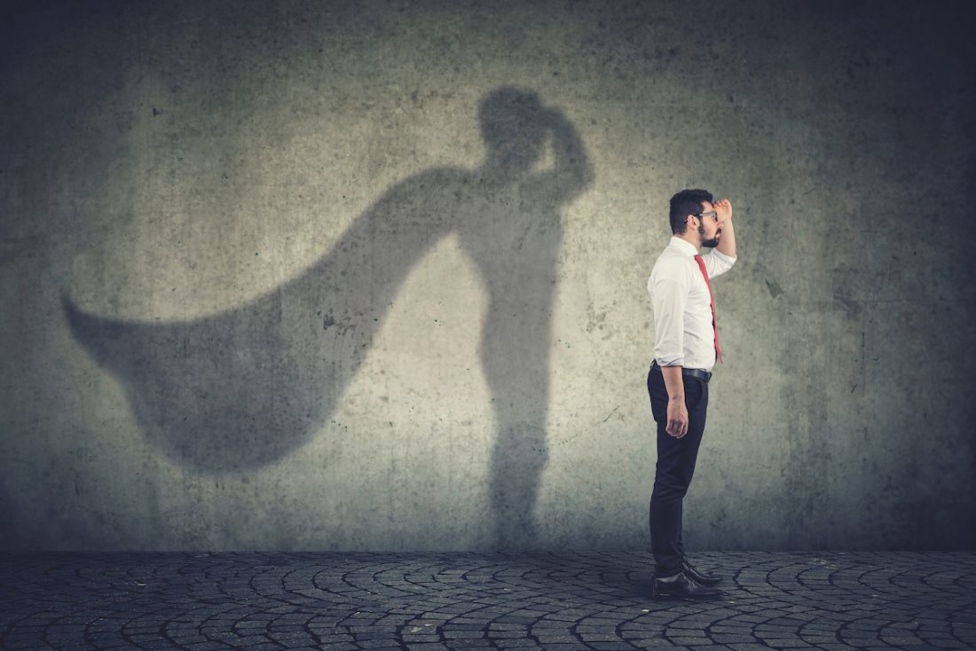 man imagining to be a super hero looking aspired work with purpose