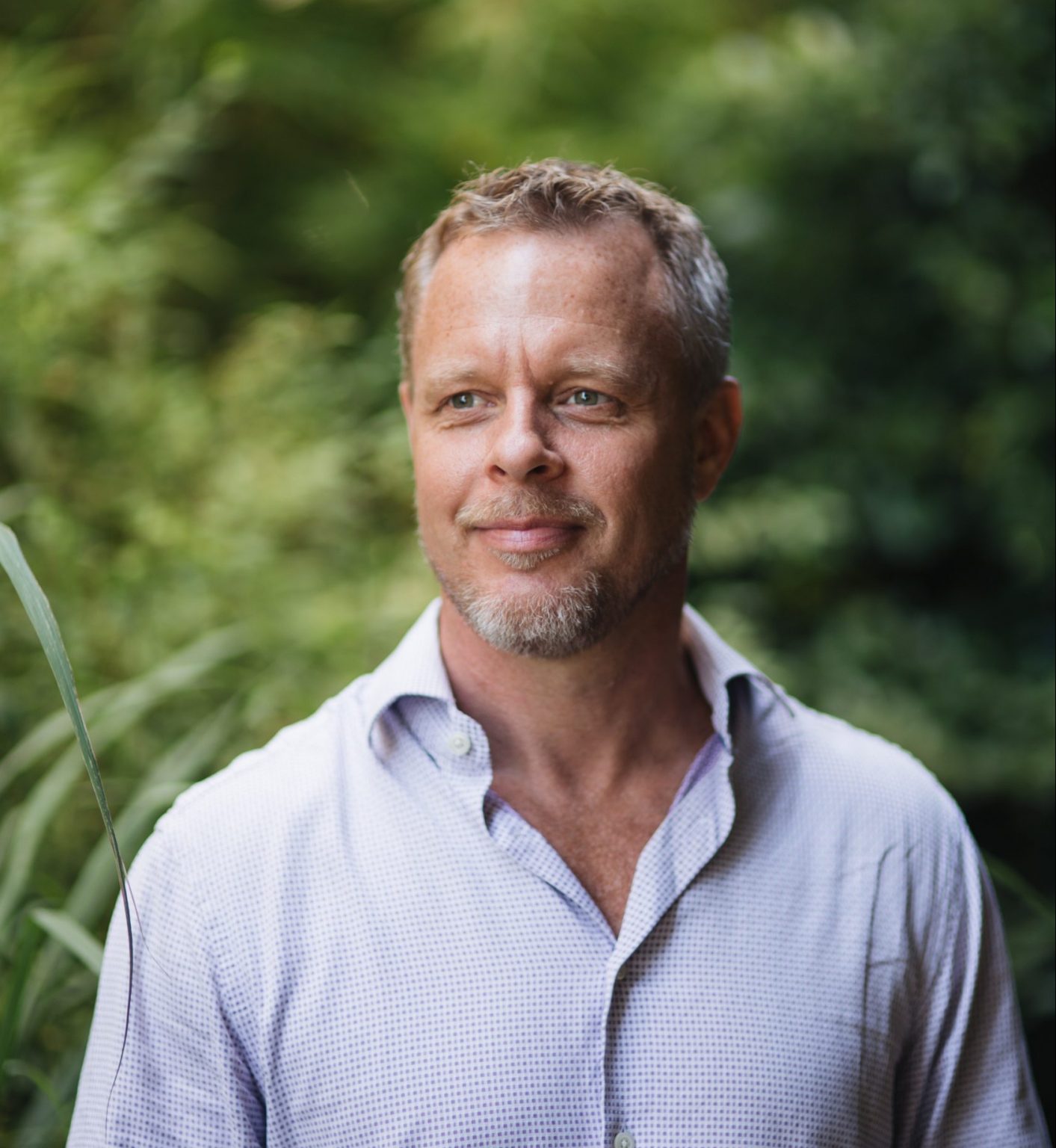 Head shot of Jonas Bengtsson with leafy backdrop