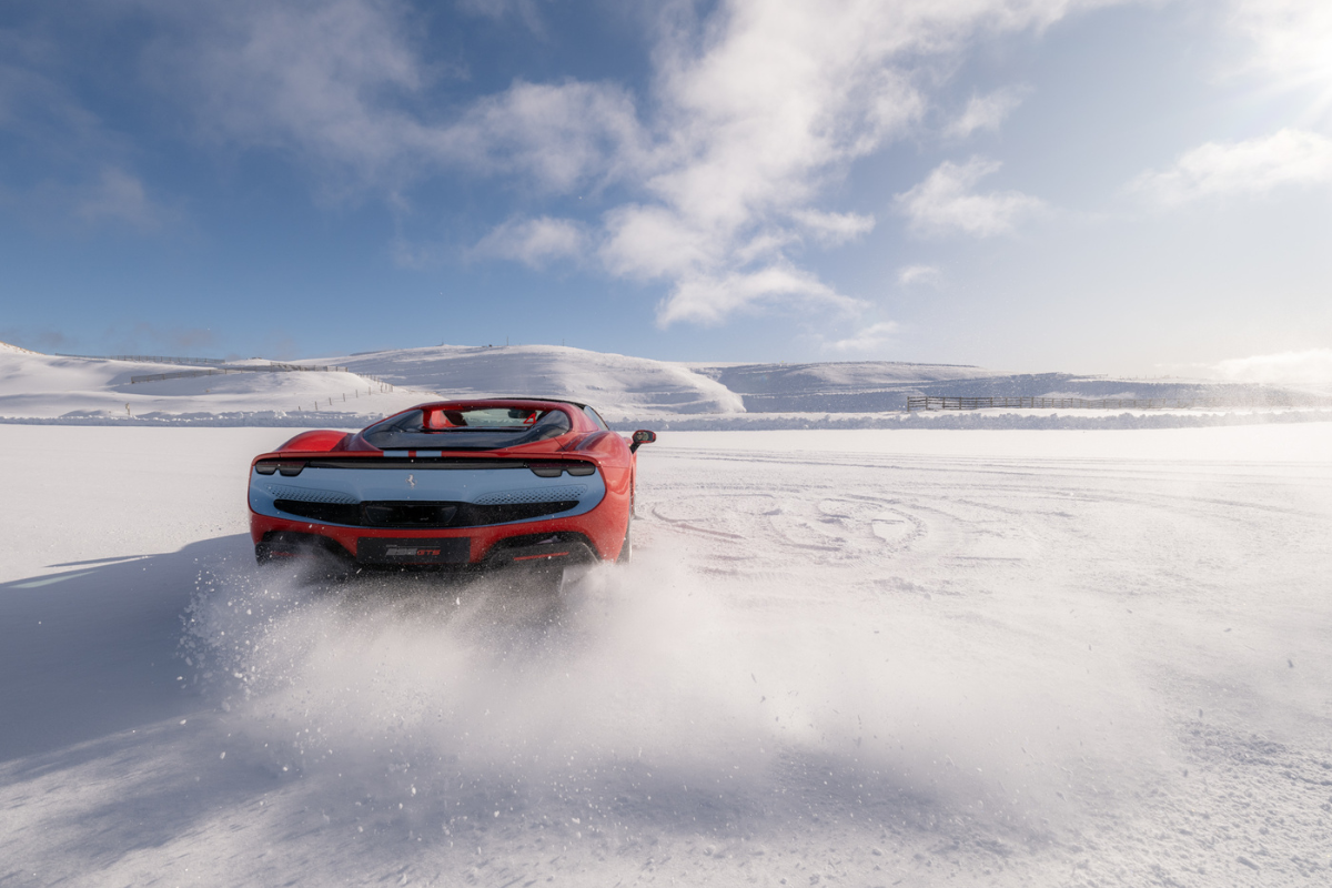 driving a red ferrari in the snow