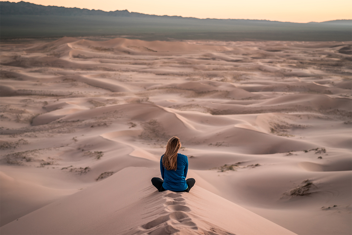 Woman sitting in the desert