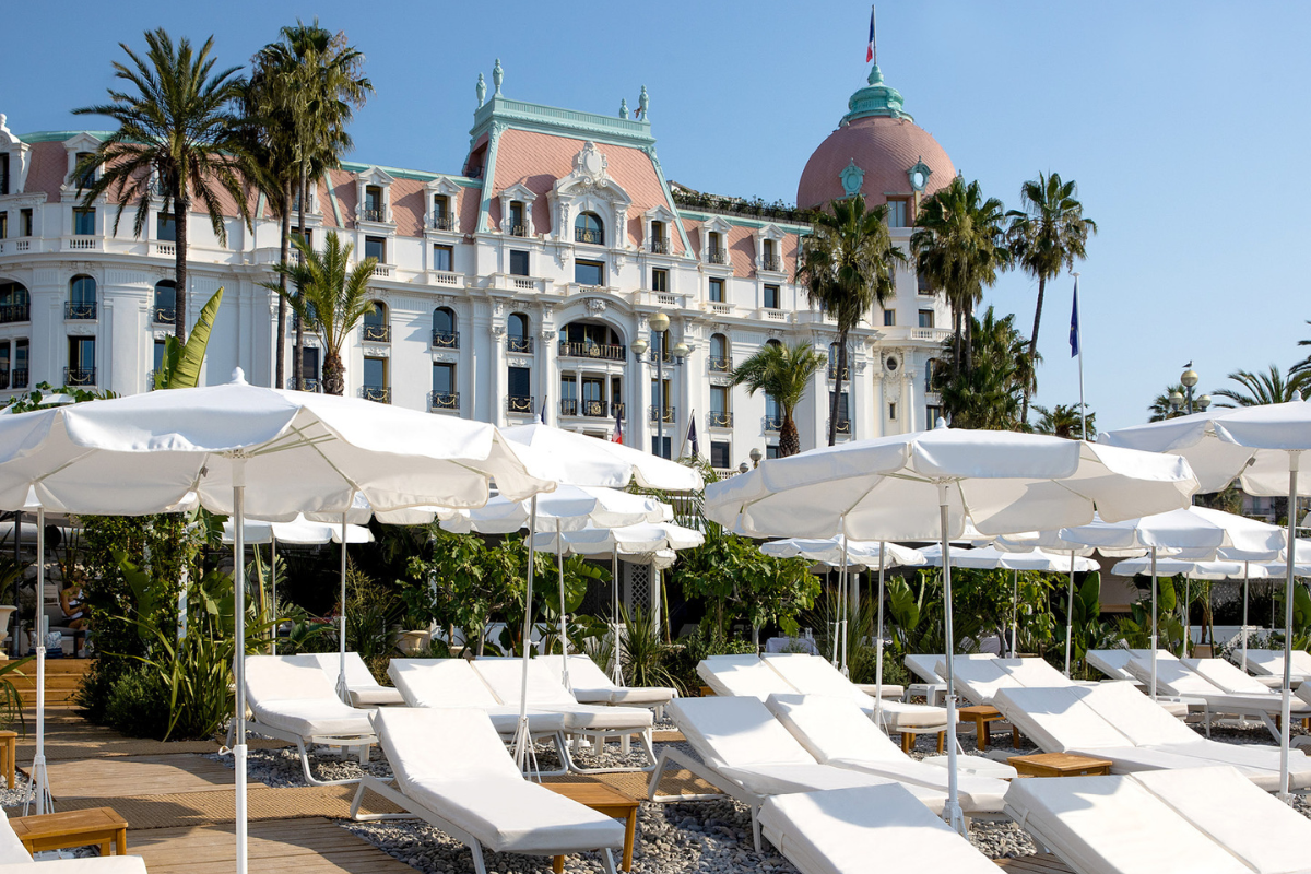 Iconic exterior of Le Negresco with sunbeds in foreground